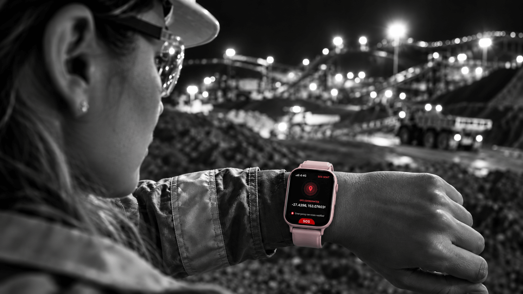 A worker at a remote night-shift mine site checking the Guardiant watch, screen showing SOS Sent and live GPS coordinates