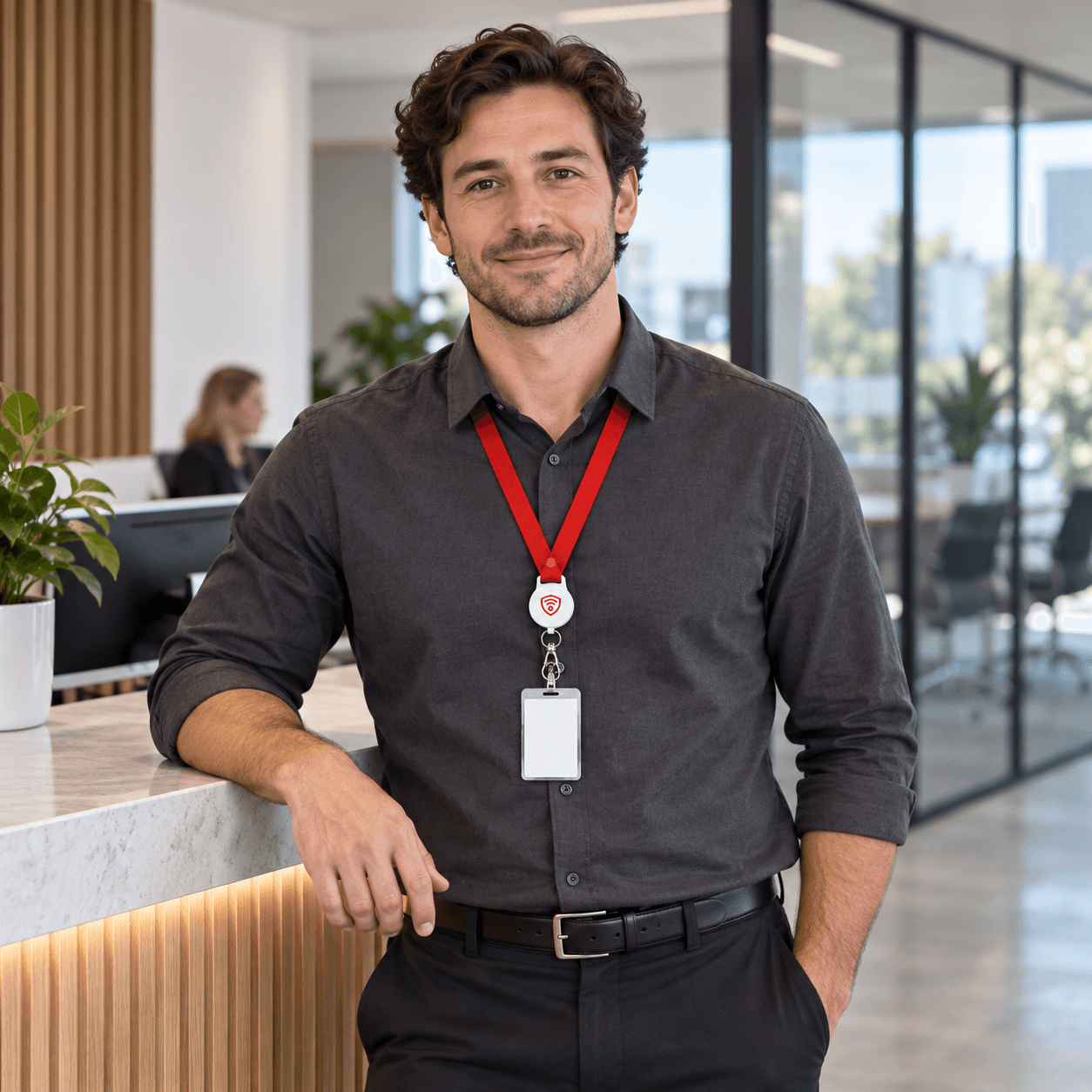 An employee wearing a Guardiant Overwatch lanyard at a workplace reception