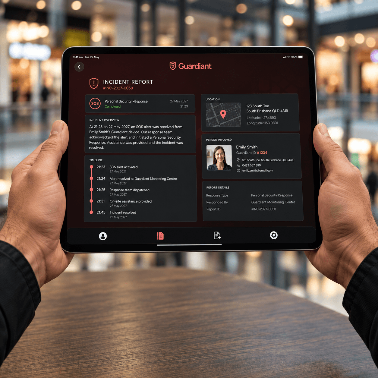 Hands holding a tablet displaying a Guardiant incident report